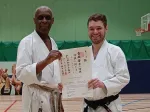 Simon being presented with yondan certificat